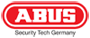 Man kan se Abus-brandets logo med hvid skrift i klare, fede store bogstaver, indrammet af en rød ellipse.